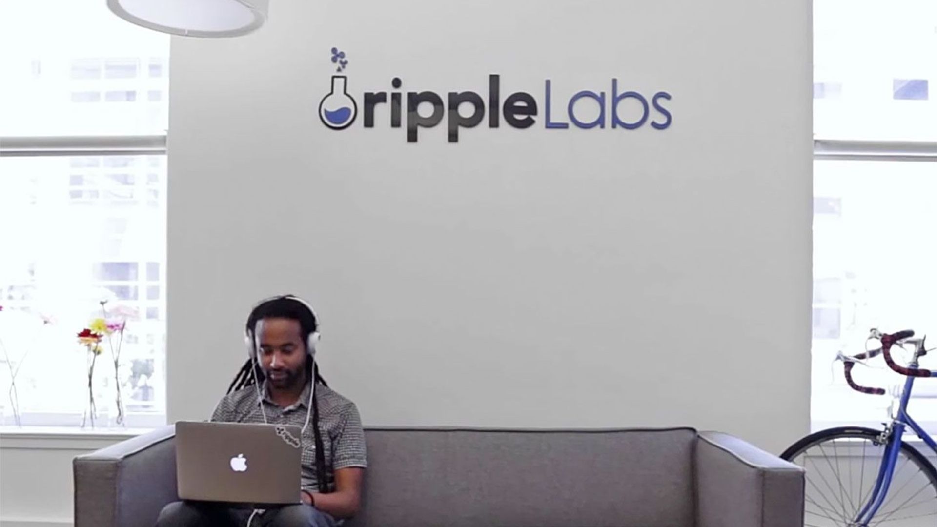Ripple Labs sign and laptop image used by CoinDesk in its report on the XRP Ledger Batch V1.1 upgrade.